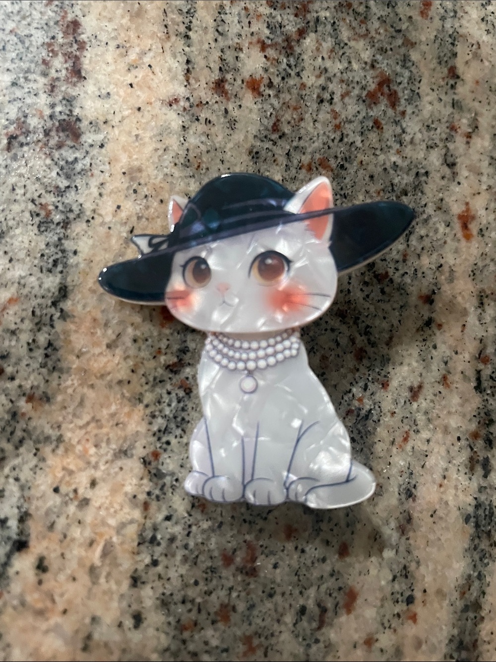 Stylish White Cat Pin with Navy Hat and Pearl Necklace